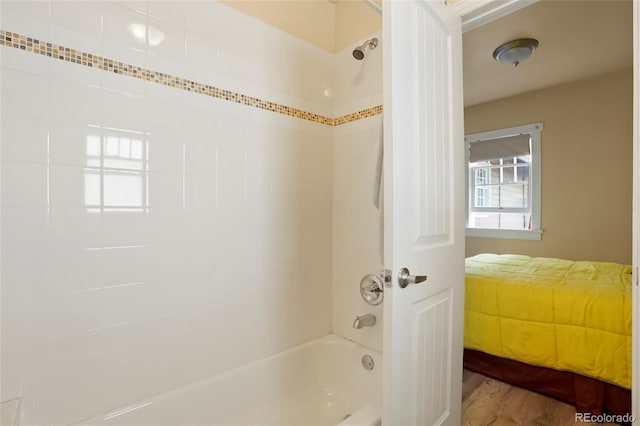 4779 S Bannock St, Englewood, CO 80110 - bathroom featuring washtub / shower combination and wood finished floors