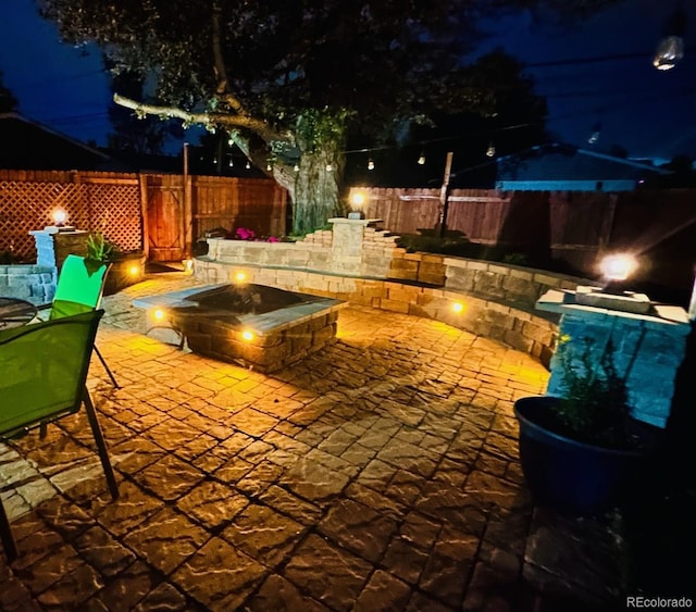 4779 S Bannock St, Englewood, CO 80110 - patio at night featuring a patio area, a fenced backyard, and a fire pit