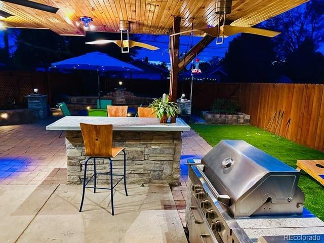 4779 S Bannock St, Englewood, CO 80110 - fenced backyard with a patio