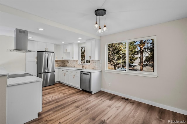 kitchen with white cabinets, pendant lighting, island exhaust hood, stainless steel appliances, and backsplash