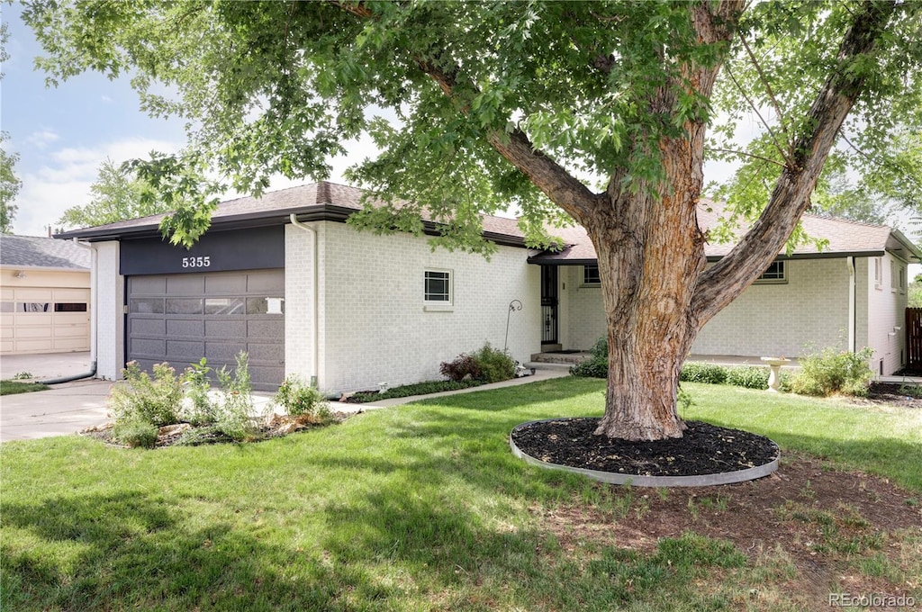 view of front facade with a garage and a front lawn