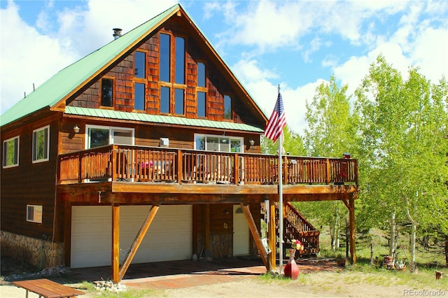 975 Windmill Dr, Hartsel, CO 80449 - rear view of property with a deck, a garage, metal roof, and stairs