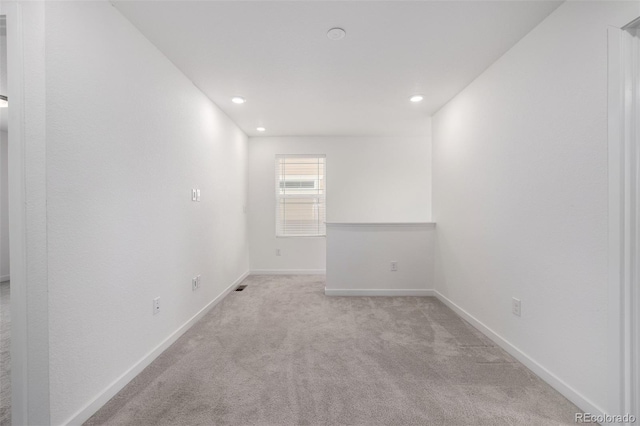 spare room with light carpet