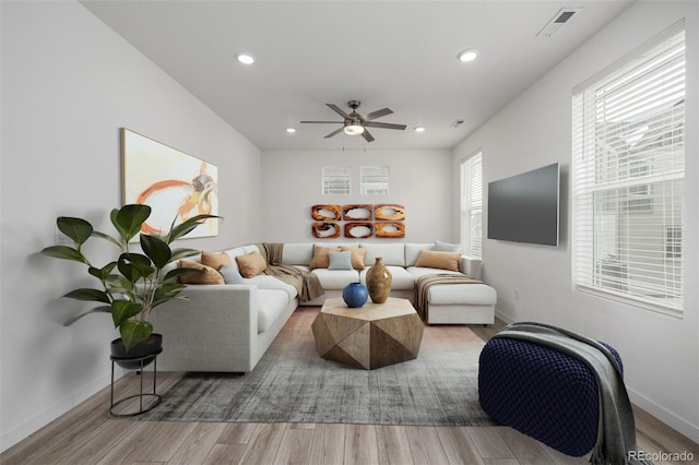 living room with ceiling fan, a healthy amount of sunlight, and hardwood / wood-style floors