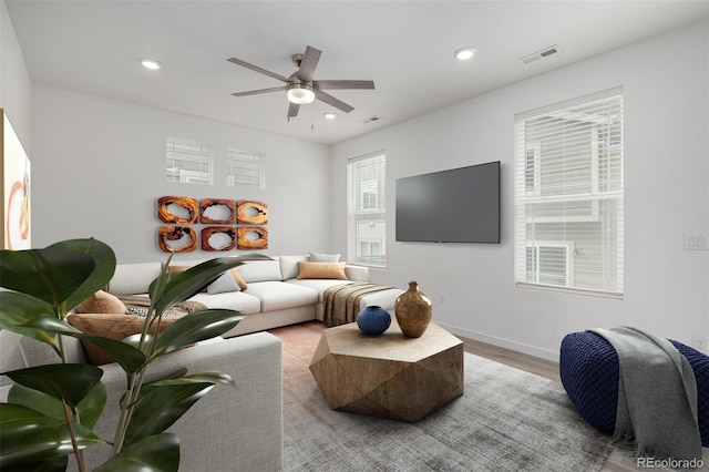 living room featuring light hardwood / wood-style floors and ceiling fan