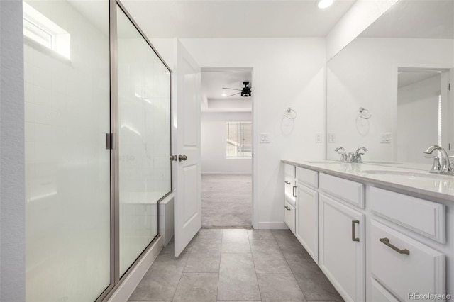 bathroom with vanity, ceiling fan, and walk in shower