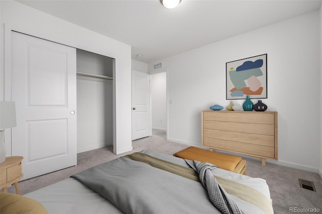 bedroom featuring light carpet and a closet