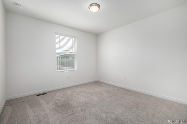 unfurnished room with light colored carpet