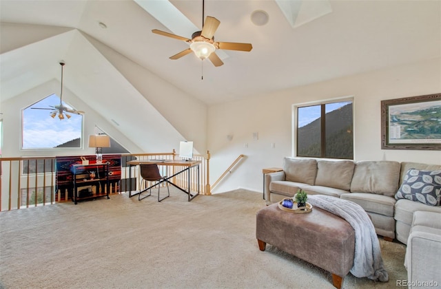 living room featuring a ceiling fan, lofted ceiling, a healthy amount of sunlight, and carpet