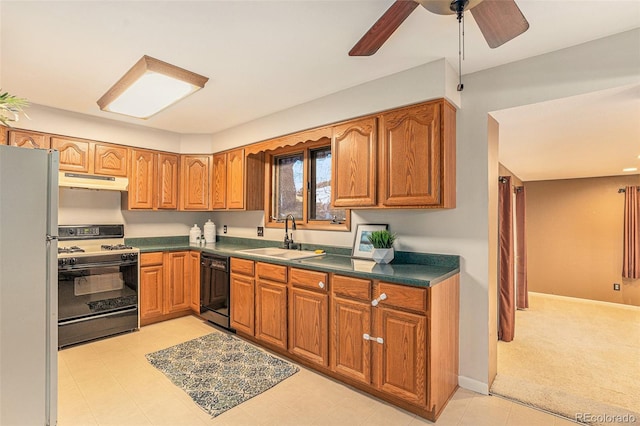 kitchen featuring dishwasher, freestanding refrigerator, gas range oven, under cabinet range hood, and a sink