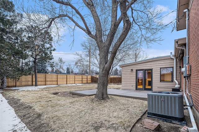 view of yard featuring central air condition unit, a fenced backyard, and a deck