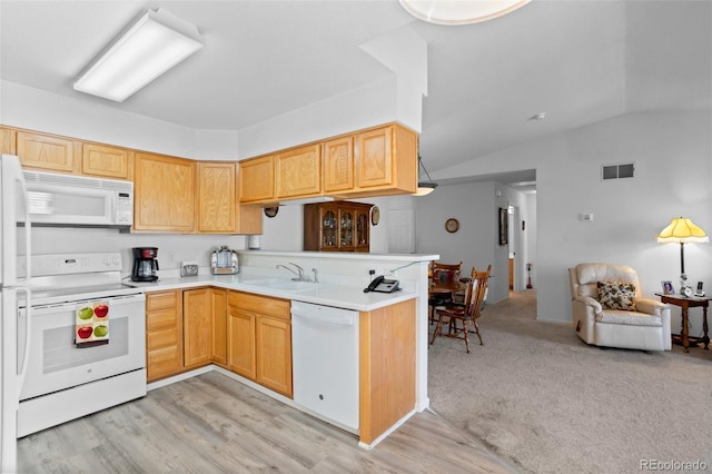 kitchen featuring vaulted ceiling, light countertops, a sink, open floor plan, and white appliances