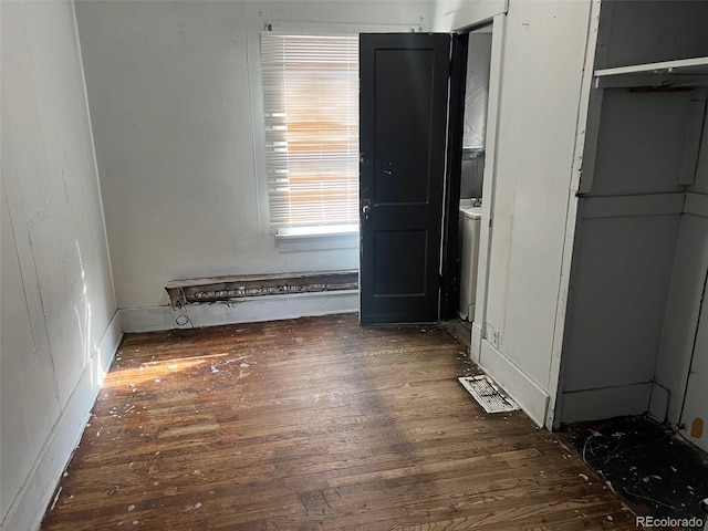 empty room featuring dark wood-type flooring