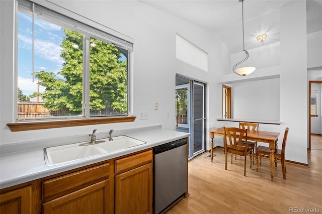 8761 Cloverleaf Cir, Parker, CO 80134 - kitchen featuring stainless steel dishwasher, healthy amount of natural light, light wood-type flooring, light countertops, and high vaulted ceiling