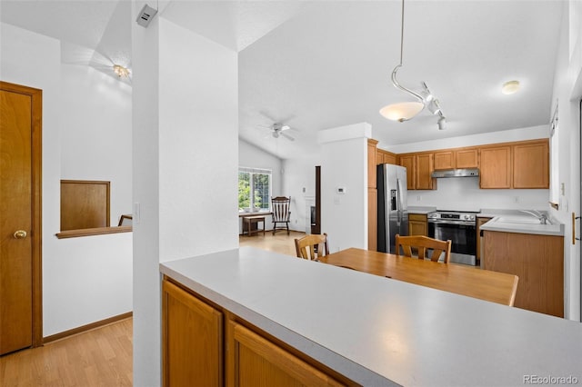 8761 Cloverleaf Cir, Parker, CO 80134 - kitchen featuring appliances with stainless steel finishes, a ceiling fan, light wood-style floors, under cabinet range hood, and light countertops