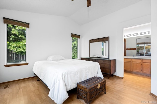 8761 Cloverleaf Cir, Parker, CO 80134 - bedroom featuring light wood finished floors, multiple windows, vaulted ceiling, and ensuite bathroom