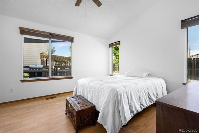 8761 Cloverleaf Cir, Parker, CO 80134 - bedroom featuring wood finished floors, vaulted ceiling, a ceiling fan, and a textured ceiling