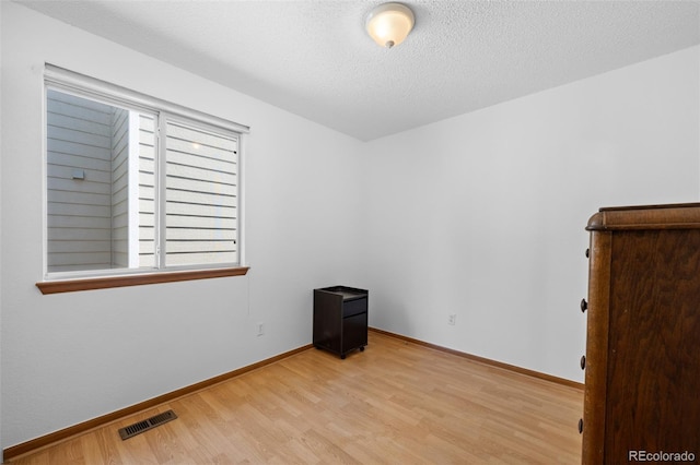 8761 Cloverleaf Cir, Parker, CO 80134 - unfurnished room with light wood-style floors and a textured ceiling