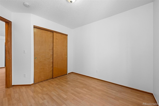 8761 Cloverleaf Cir, Parker, CO 80134 - unfurnished bedroom featuring light wood finished floors, a closet, and a textured ceiling