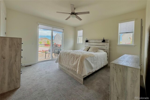 bedroom featuring multiple windows, carpet flooring, and access to outside