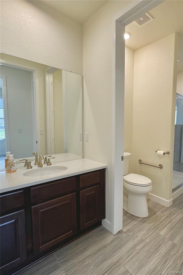 bathroom featuring tile patterned floors, toilet, and vanity