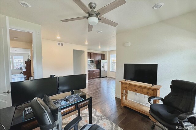 living room with ceiling fan and dark hardwood / wood-style flooring