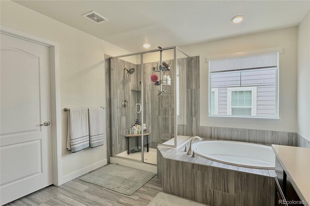 bathroom featuring shower with separate bathtub