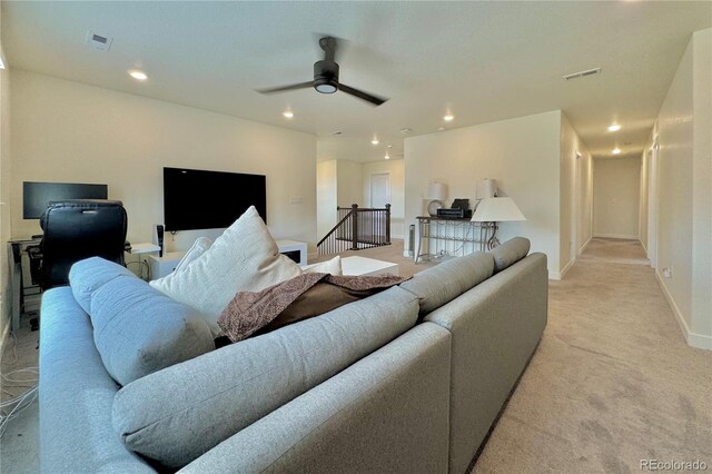 carpeted living room with ceiling fan