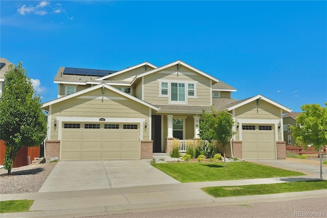 craftsman-style home featuring a garage and solar panels