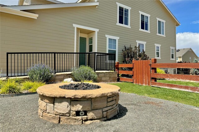 back of house with an outdoor fire pit