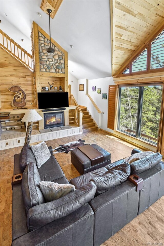320 Summit Rd, Woodland Park, CO 80863 - living room with lofted ceiling, stairs, wood finished floors, and a glass covered fireplace