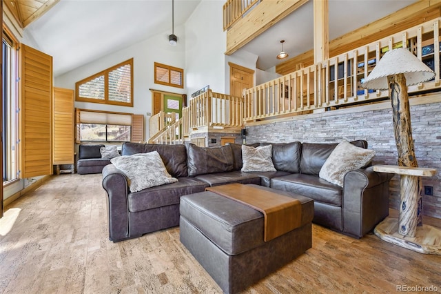 320 Summit Rd, Woodland Park, CO 80863 - living area featuring wood finished floors, high vaulted ceiling, plenty of natural light, and stairway