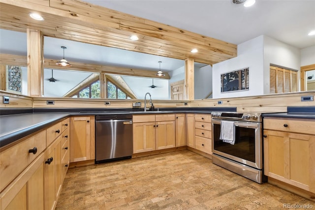 320 Summit Rd, Woodland Park, CO 80863 - kitchen featuring stainless steel appliances, light brown cabinets, dark countertops, and recessed lighting