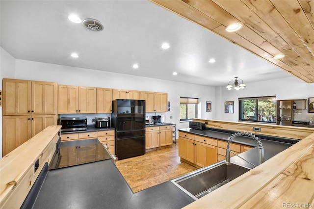320 Summit Rd, Woodland Park, CO 80863 - kitchen featuring freestanding refrigerator, light brown cabinetry, dark countertops, a chandelier, and stainless steel microwave