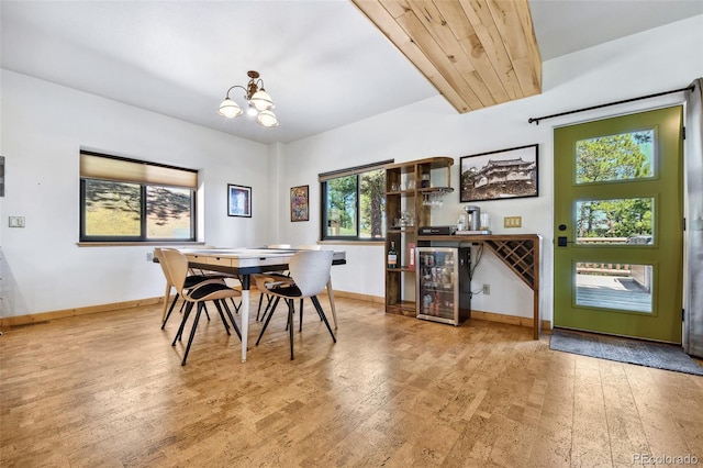 320 Summit Rd, Woodland Park, CO 80863 - dining space featuring hardwood / wood-style flooring, baseboards, a chandelier, and beverage cooler