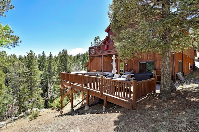 320 Summit Rd, Woodland Park, CO 80863 - wooden terrace with an outdoor living space and a wooded view