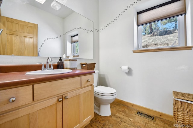 320 Summit Rd, Woodland Park, CO 80863 - bathroom featuring toilet, wood finished floors, baseboards, and vanity