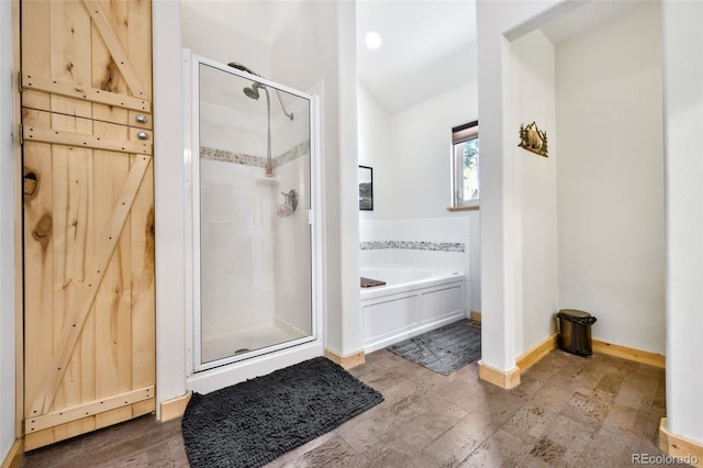 320 Summit Rd, Woodland Park, CO 80863 - full bath with a shower stall, a garden tub, lofted ceiling, and baseboards