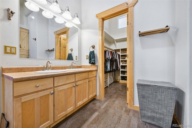 320 Summit Rd, Woodland Park, CO 80863 - bathroom with wood finished floors, vanity, and a walk in closet