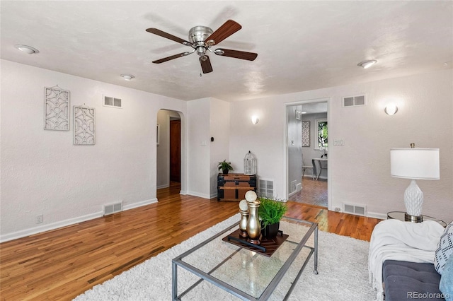 living room with ceiling fan and wood-type flooring