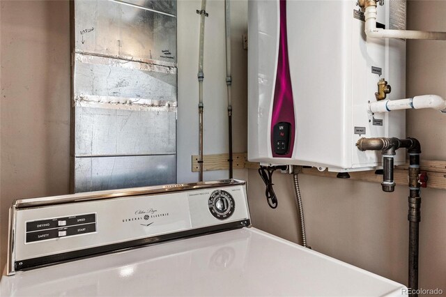 laundry room featuring tankless water heater and washer / clothes dryer