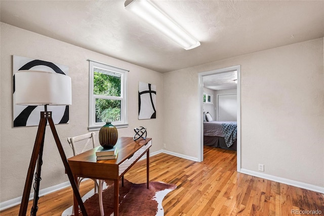 office area with light hardwood / wood-style floors