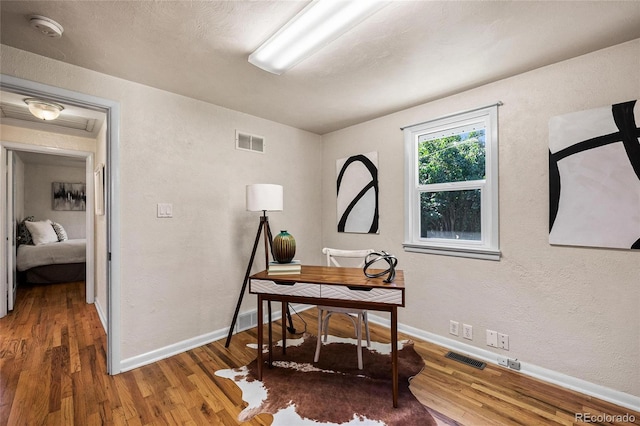 office space with wood-type flooring