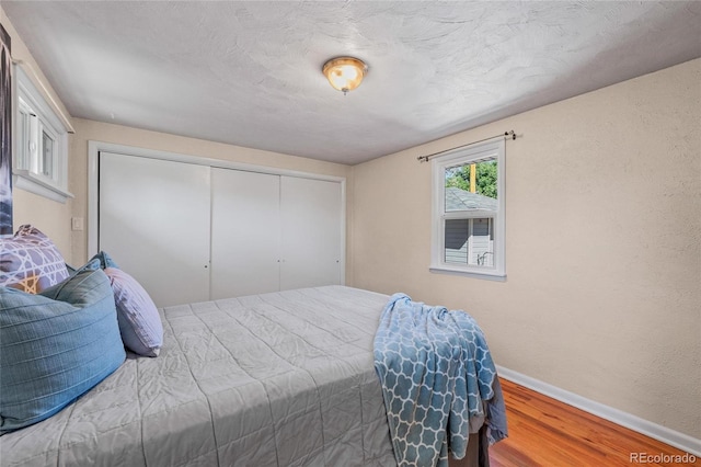 bedroom featuring a closet and hardwood / wood-style flooring