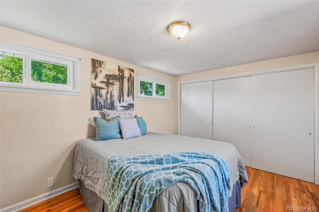 bedroom with a closet and hardwood / wood-style flooring