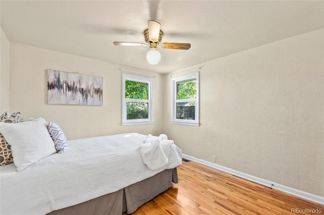 bedroom with ceiling fan and light hardwood / wood-style floors