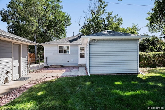 back of property featuring a lawn and a patio area