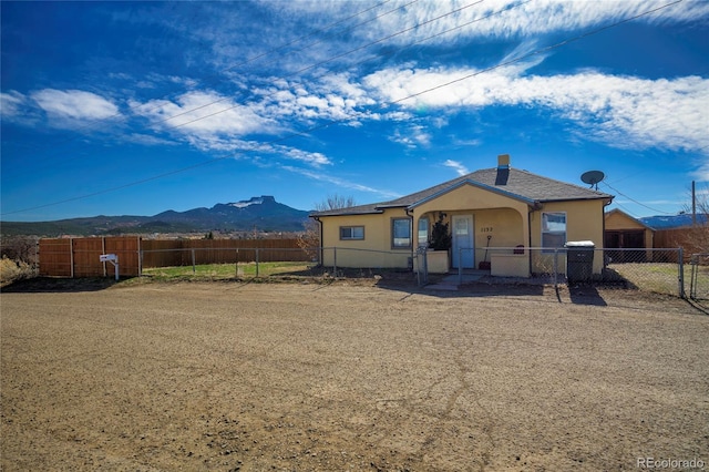 rear view of house featuring a mountain view