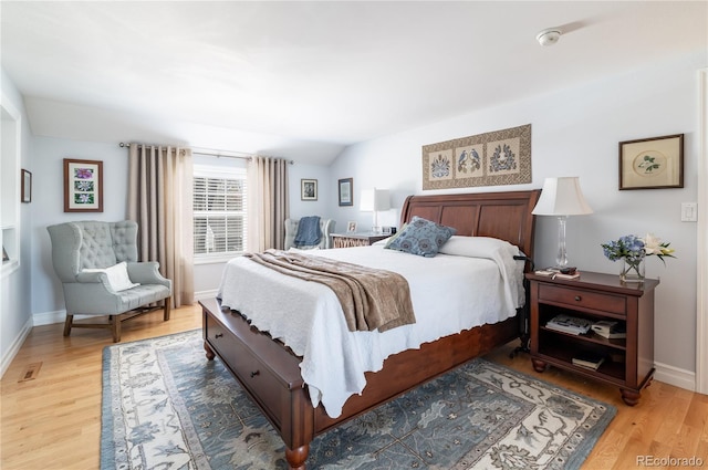 bedroom with light wood-type flooring and baseboards