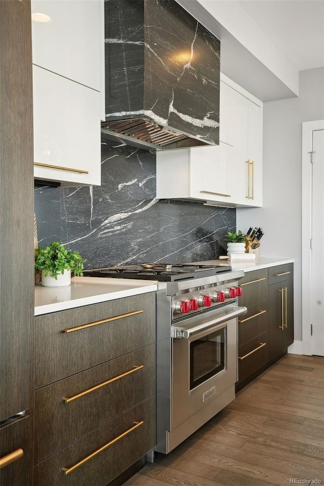 kitchen featuring premium range, white cabinets, custom exhaust hood, dark wood-style floors, and modern cabinets